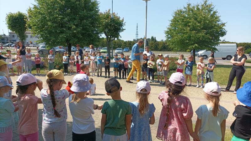 Zdjęcie kolorowe, Pan Poeta na spotkaniu z przedszkolakami przed Biblioteką